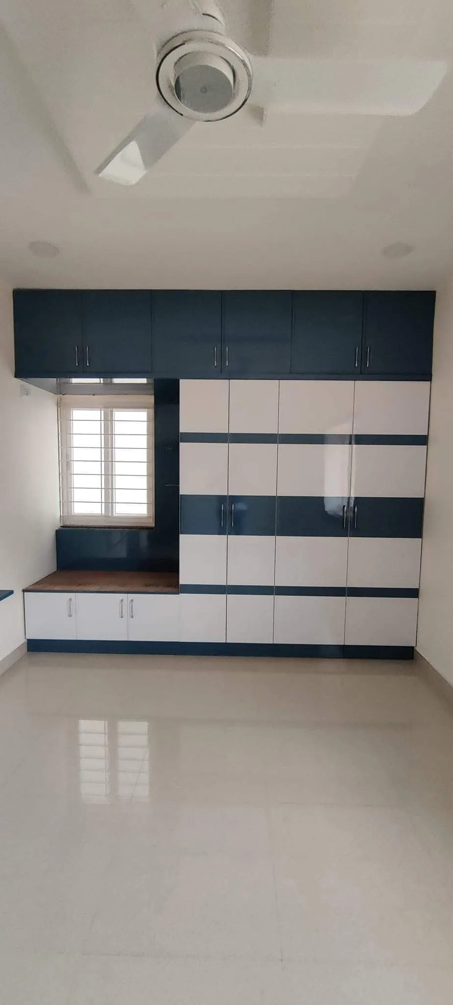 Navy and white hinged wardrobe with loft storage