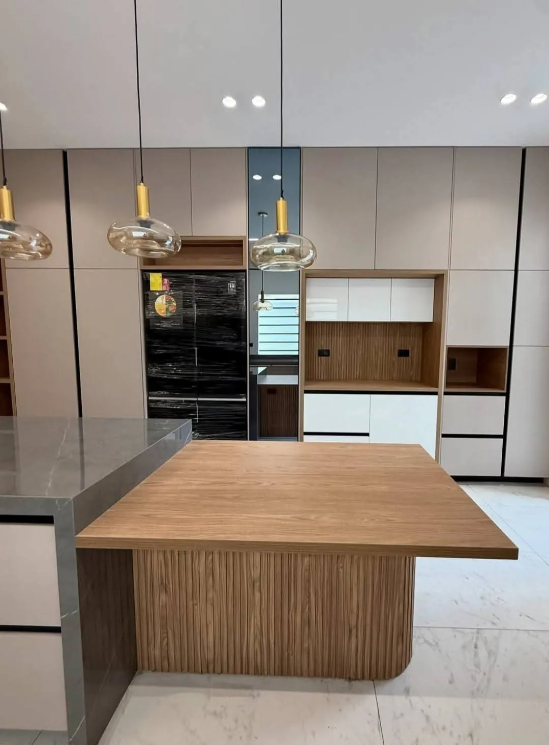 Modern kitchen with black glossy cabinets, wooden island and pendant lights