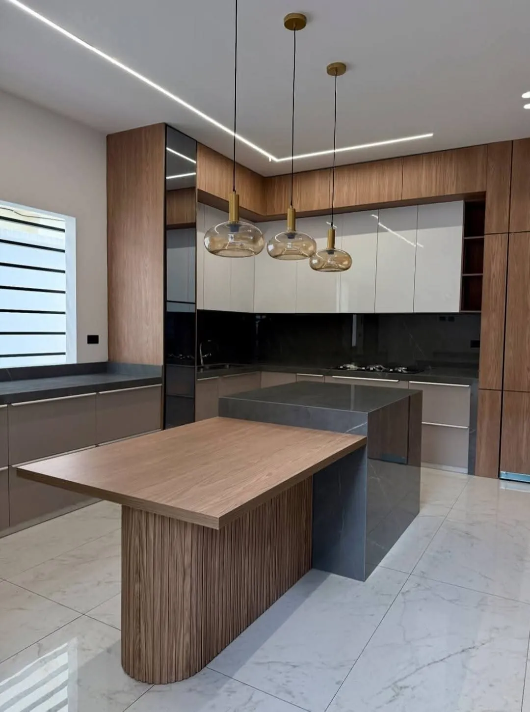Modular kitchen with wooden island counter and pendant lights